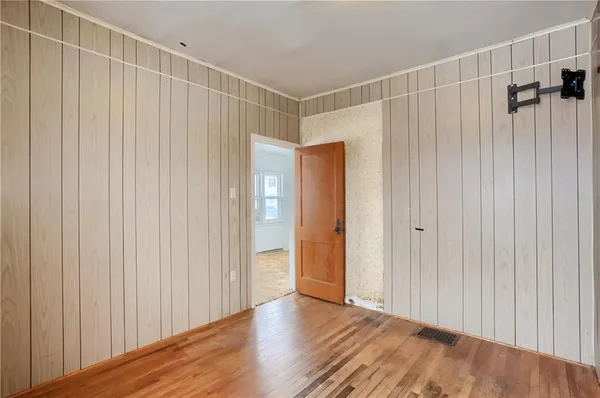 a view of a room with wooden floor and windows