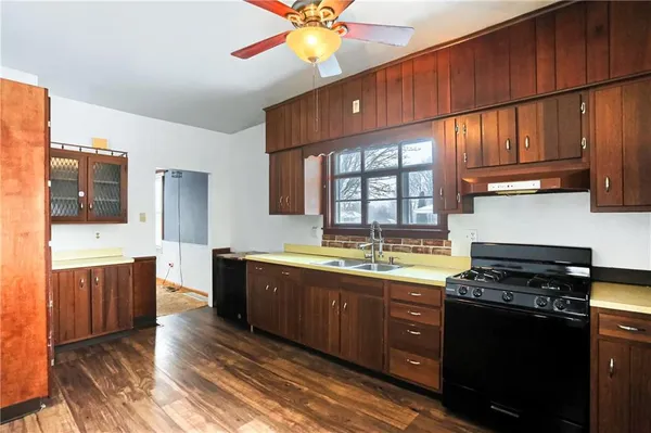 a kitchen with stainless steel appliances granite countertop a stove a sink and a microwave