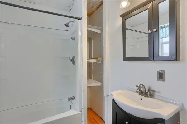 a bathroom with a sink a shower and a mirror