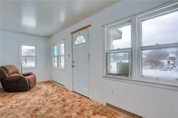 a bedroom with a bed and glass window