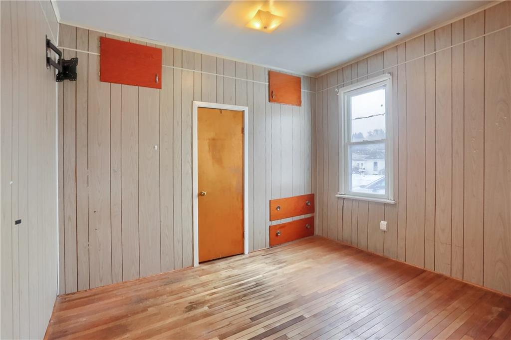 314 13th Street Bessemer, PA 16112 - Photo 9 of 26 a view of an empty room with wooden floor and a window