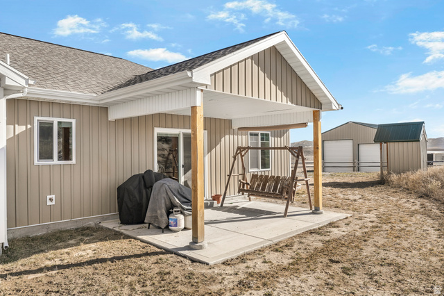 18573 South Marsh Valley Road Downey, ID 83234 - Photo 22 of 32 View of patio featuring an outbuilding and a detached garage