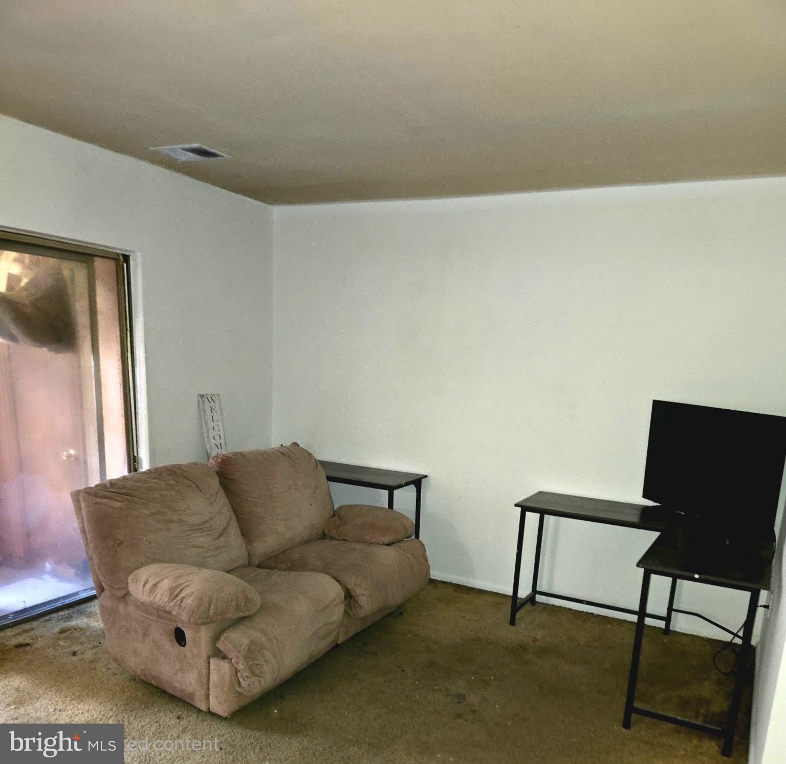 3384 Hewitt Avenue, Unit 201 Silver Spring, MD 20906 - Photo 2 of 10 a living room with furniture and a window