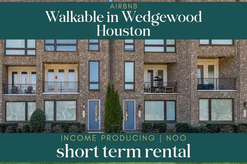 front view of a brick house with a yard