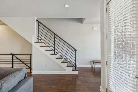 a living room with furniture wooden floor and a flat screen tv