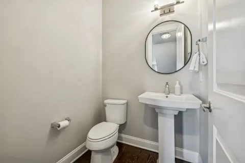 a living room with furniture a dining table and a chandelier