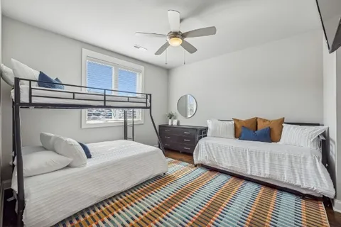 a bedroom with a bed and a potted plant