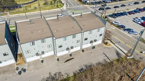 a front view of a building with a garden