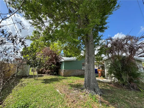 a pathway of a house with a yard