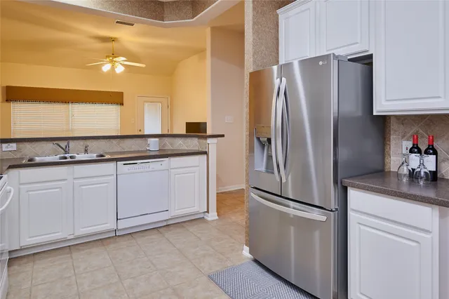 a kitchen with stainless steel appliances granite countertop a refrigerator and a stove