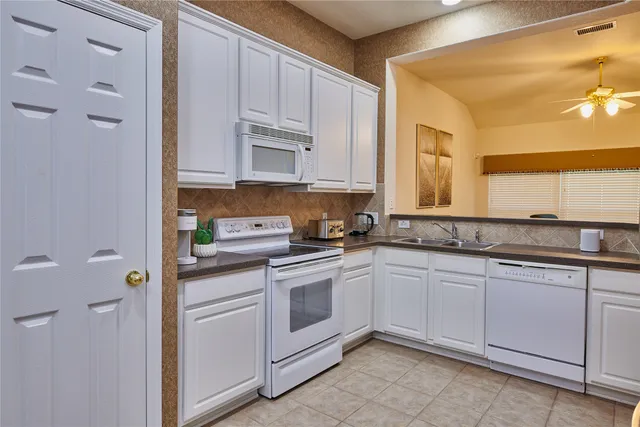 a kitchen with cabinets appliances and a counter top