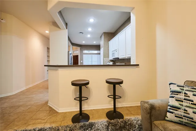 a kitchen with stainless steel appliances kitchen island granite countertop a sink and cabinets