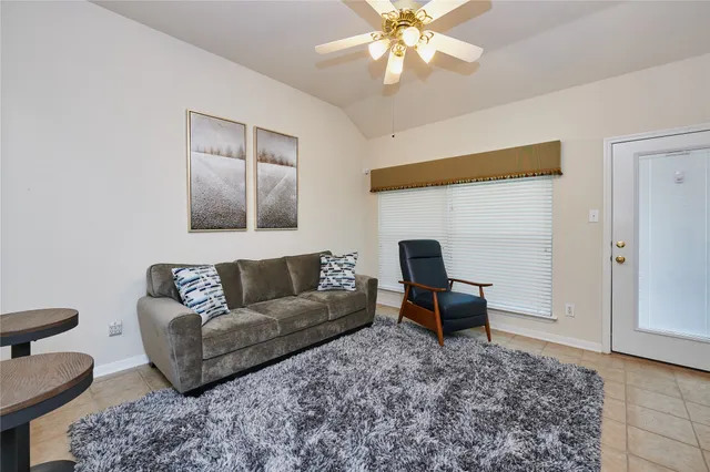 a living room with furniture and a rug