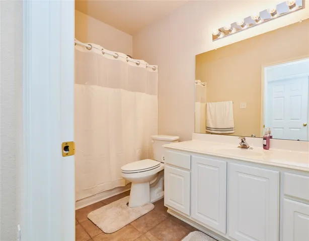 a bathroom with a sink toilet a mirror and shower