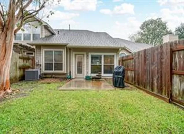a view of a house with backyard porch and sitting area