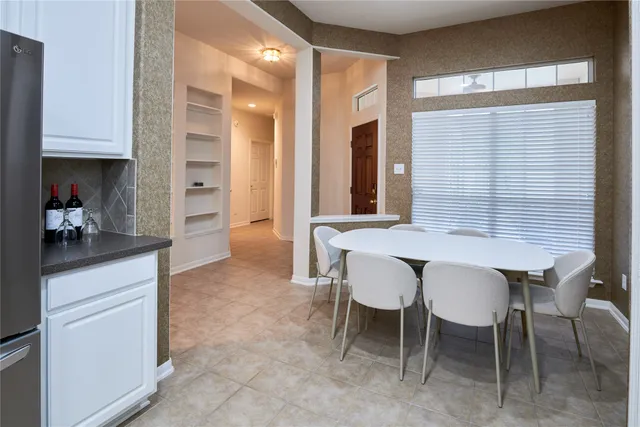 a dining room with furniture and window