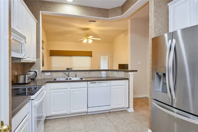 a kitchen with a sink and refrigerator