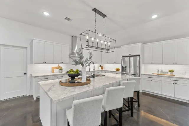 a kitchen with kitchen island granite countertop a table and chairs