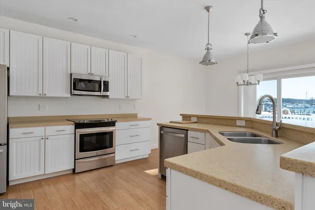 a kitchen with granite countertop a sink and a stove top oven