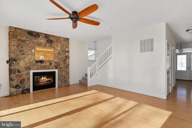 a bedroom with a fireplace and a ceiling fan