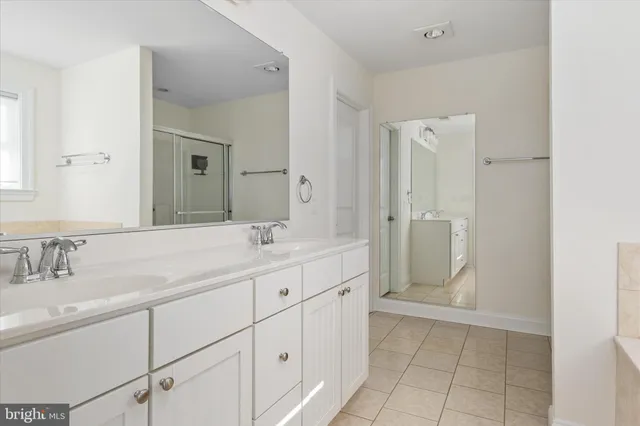 a bathroom with a double vanity sink mirror and double