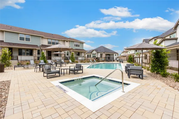 a building outdoor space with patio furniture and potted plants