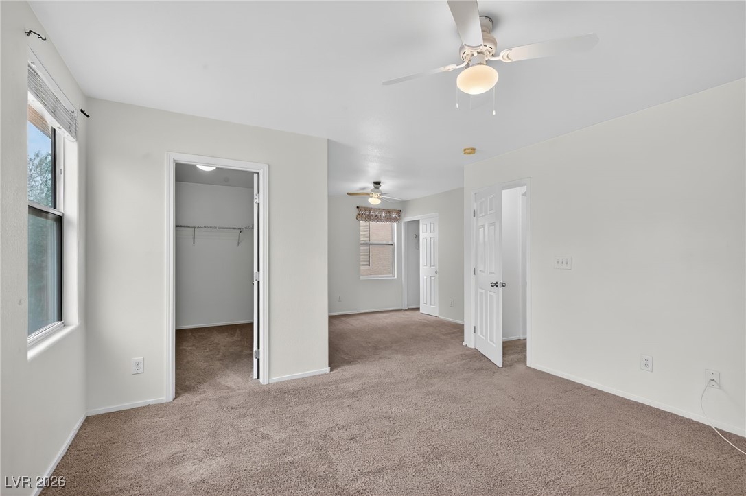 8038 Kings Ransom Street Las Vegas, NV 89139 - Photo 16 of 38 Unfurnished bedroom with a ceiling fan, carpet floors, and a walk in closet