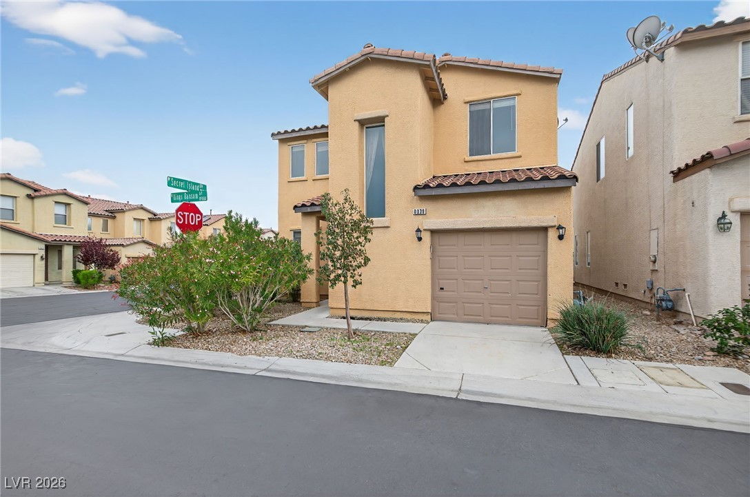 8038 Kings Ransom Street Las Vegas, NV 89139 - Photo 2 of 38 Mediterranean / spanish house with a tile roof, stucco siding, a garage, and driveway