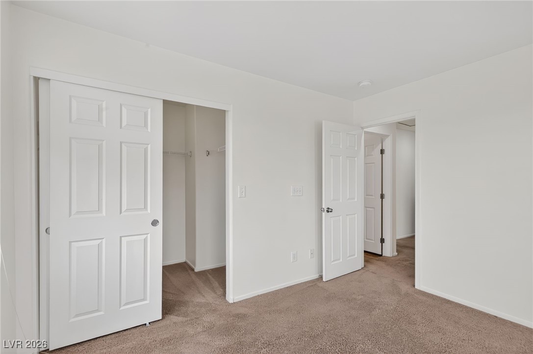 8038 Kings Ransom Street Las Vegas, NV 89139 - Photo 29 of 38 Unfurnished bedroom featuring carpet floors and a walk in closet