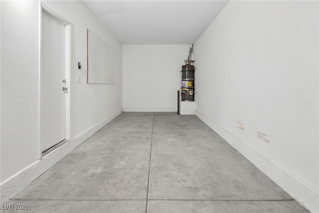 8038 Kings Ransom Street Las Vegas, NV 89139 - Photo 32 of 38 Garage featuring strapped water heater and baseboards