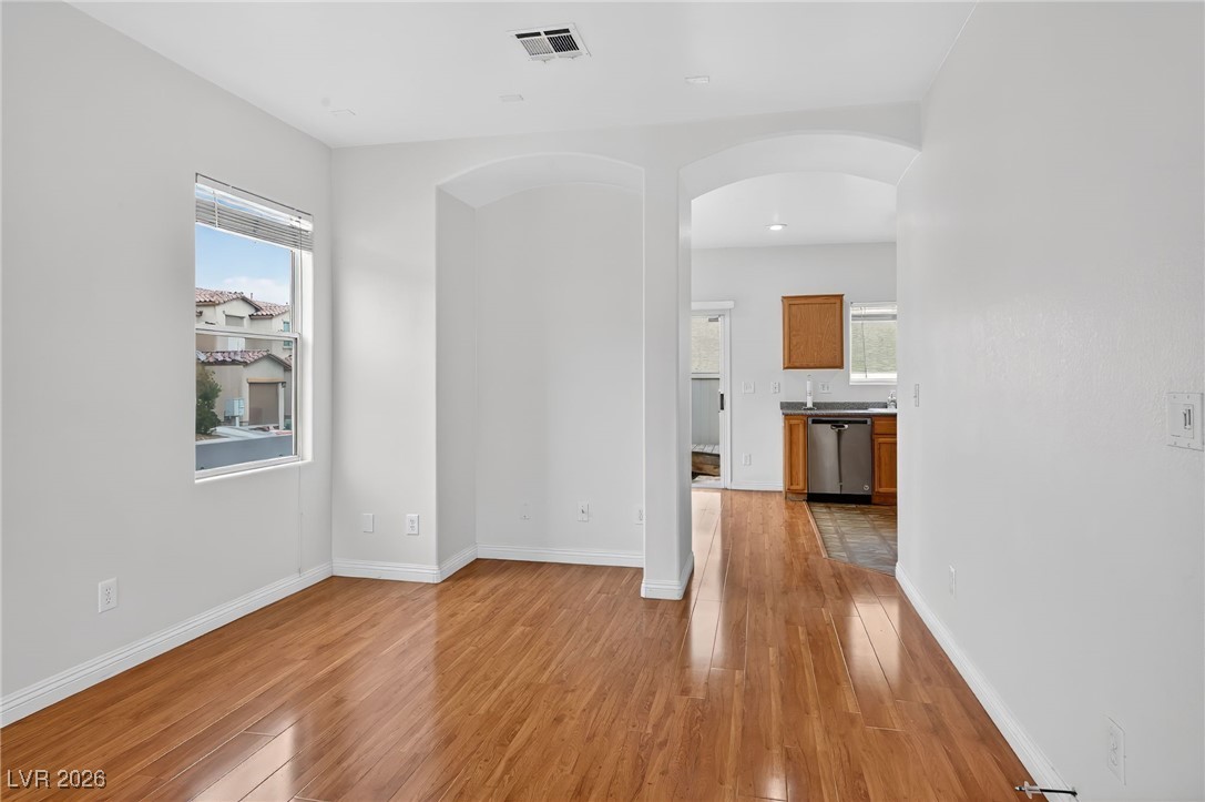 8038 Kings Ransom Street Las Vegas, NV 89139 - Photo 4 of 38 Spare room with arched walkways, light wood-style floors, and plenty of natural light