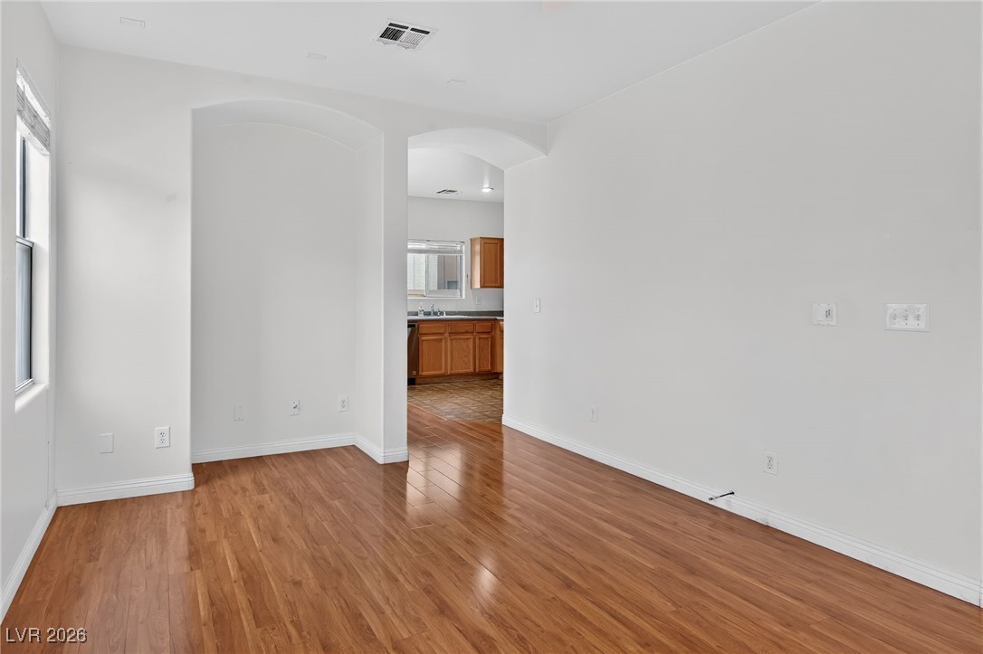 8038 Kings Ransom Street Las Vegas, NV 89139 - Photo 6 of 38 Spare room featuring arched walkways and light wood-type flooring