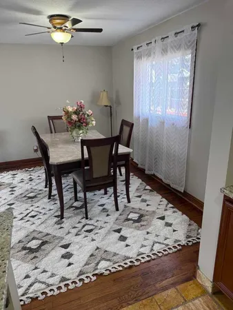 a view of a dining room with furniture and chandelier