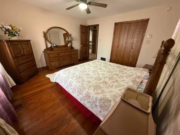a bedroom with a bed and a dresser