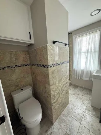 a bathroom with a toilet and a shower