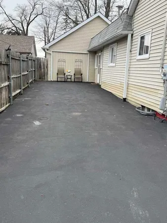 a view of a house with a backyard