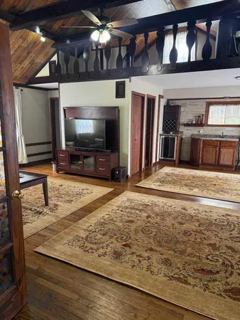 a living room with fireplace furniture and a flat screen tv