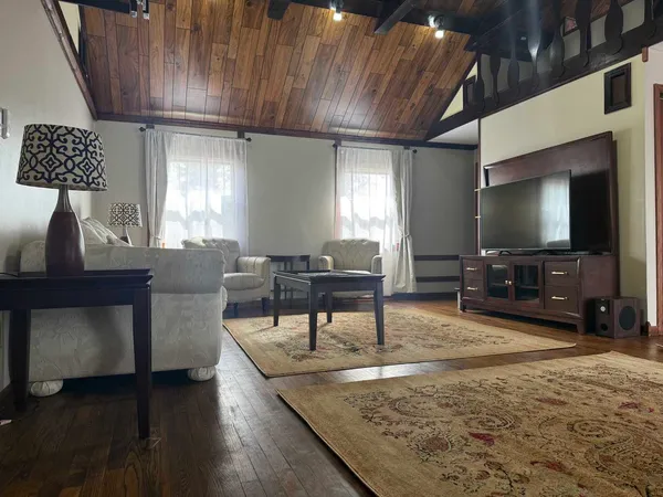 a living room with furniture and a flat screen tv