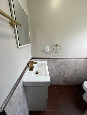 a bathroom with a sink and mirror