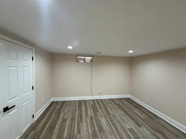 a view of a room with wooden floor