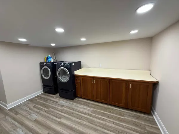 a view of a storage & utility room with two washing machine