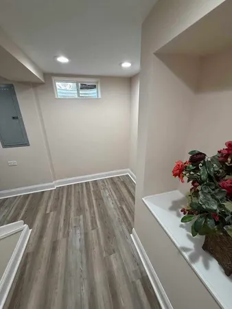a room with wooden floor and flower pot