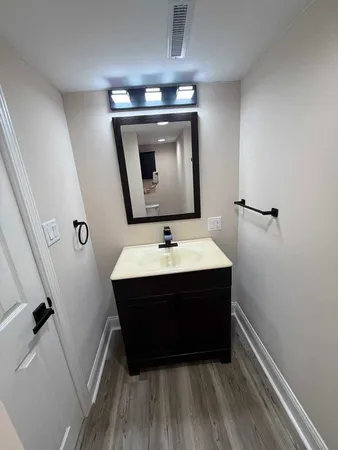 a room with a sink and a mirror