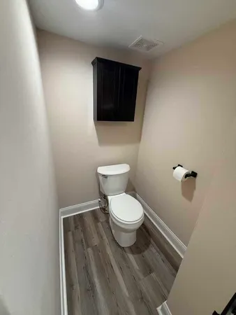 a white toilet sitting next to a small sink