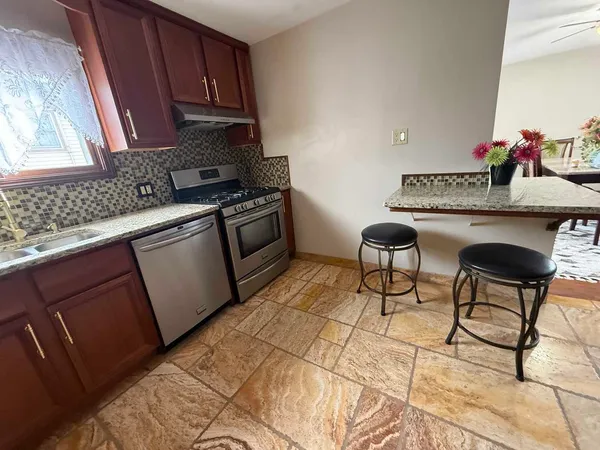 a kitchen with stainless steel appliances granite countertop a sink and cabinets