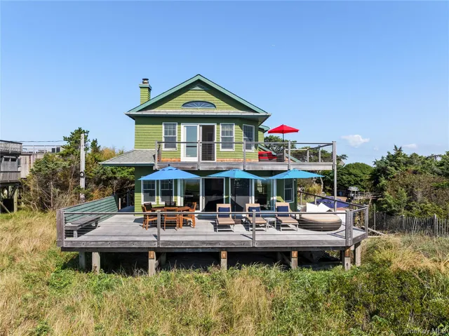 a front view of a house with swimming pool garden and patio