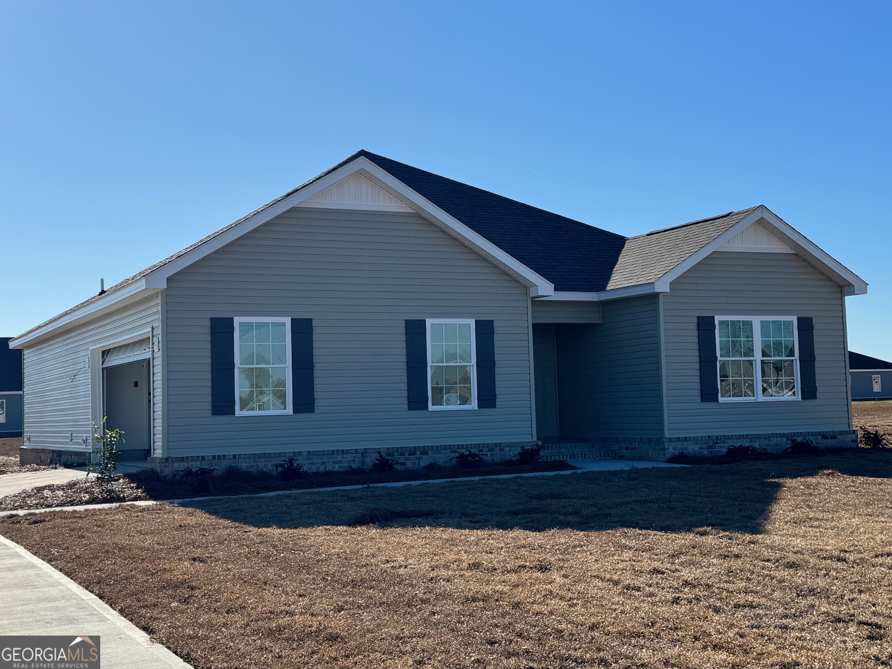 64 Pampas Road Statesboro, GA 30458 - Photo 2 of 13 a front view of a house with a yard