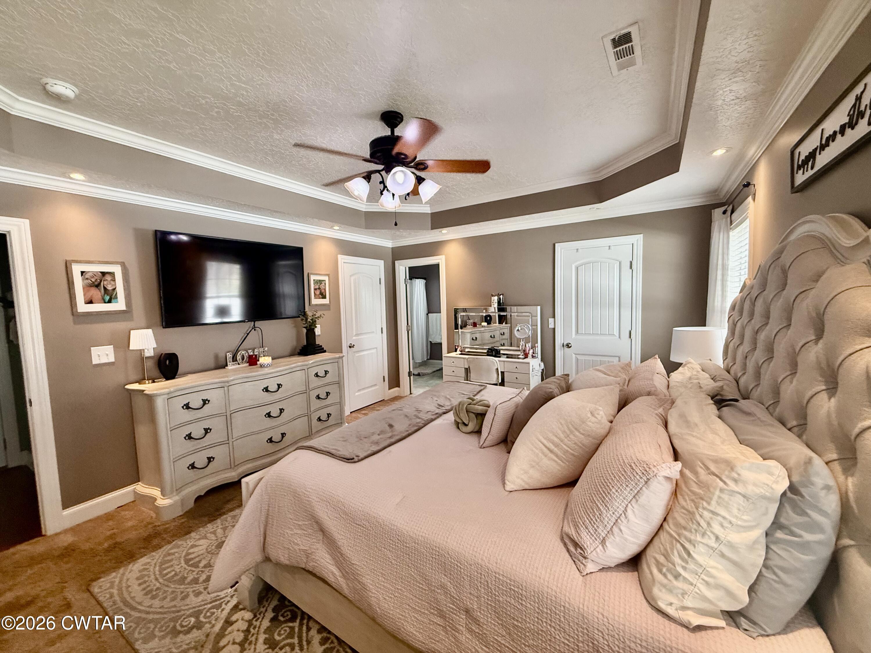 601 Locust Street Troy, TN 38260 - Photo 13 of 22 a bedroom with a bed and a flat screen tv
