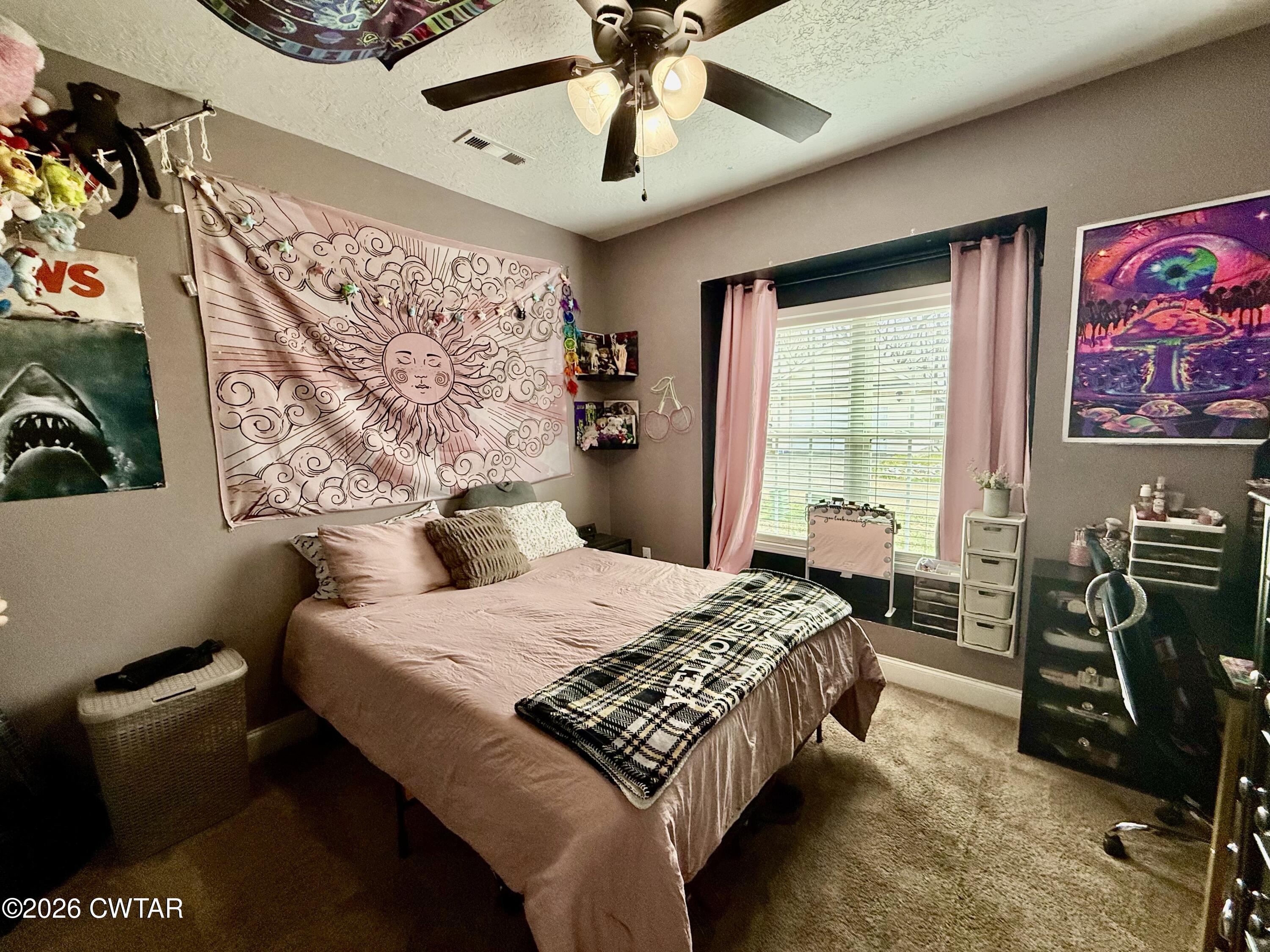 601 Locust Street Troy, TN 38260 - Photo 14 of 22 a bedroom with a bed and a chandelier