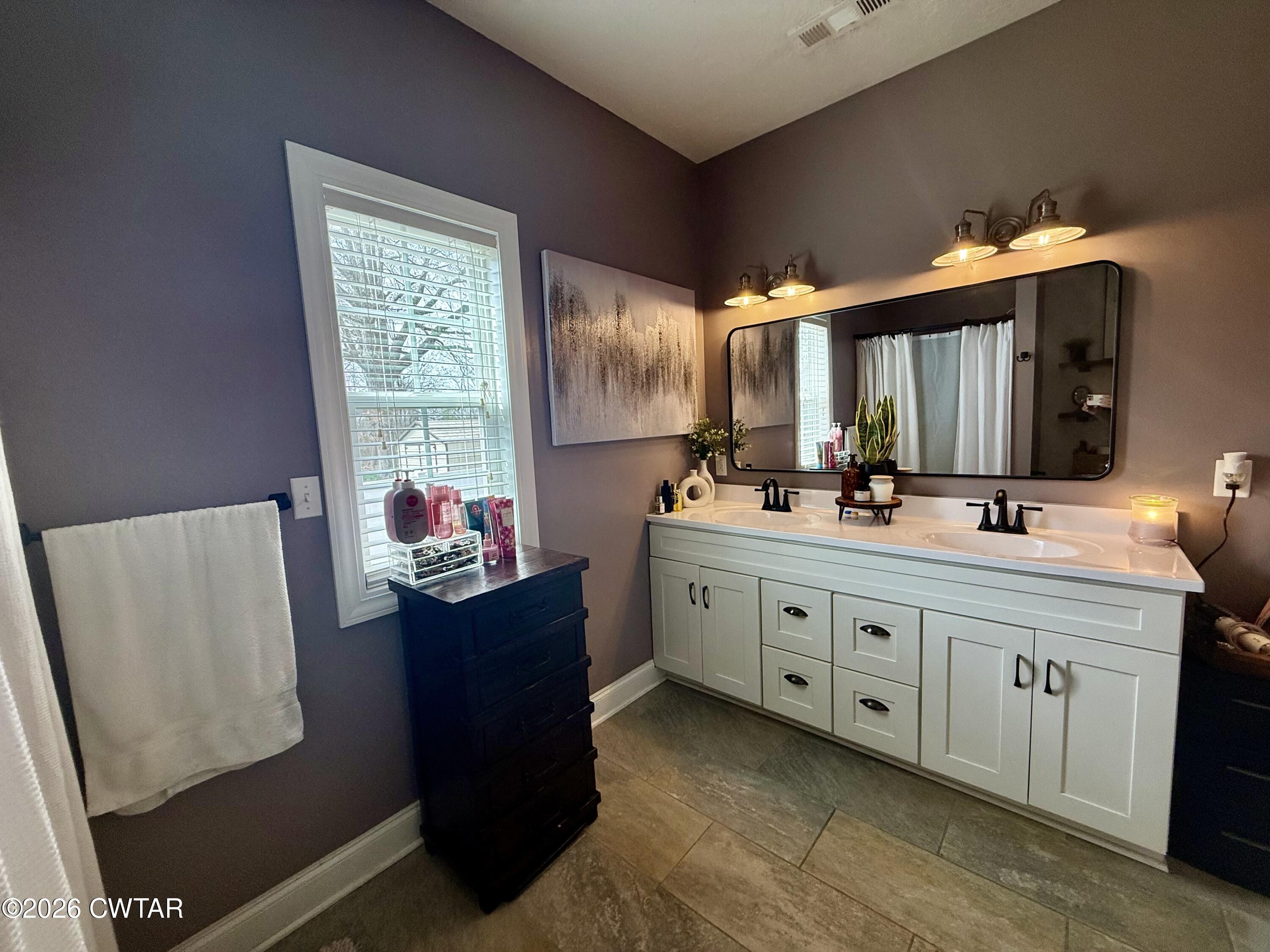 601 Locust Street Troy, TN 38260 - Photo 15 of 22 a bathroom with a sink vanity and mirror